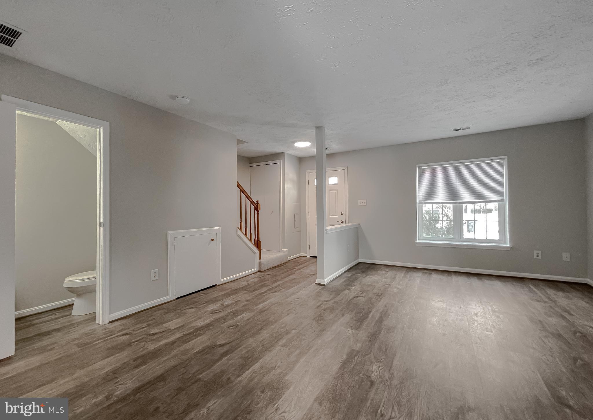 4232 Drake Court Waldorf, MD 20603 - Photo 4 of 25 an empty room with wooden floor and windows