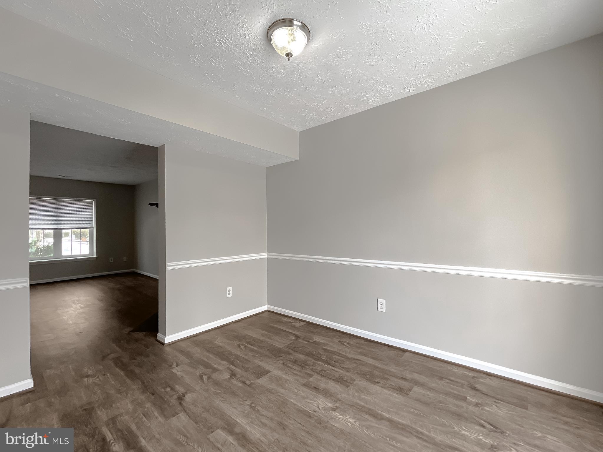 4232 Drake Court Waldorf, MD 20603 - Photo 7 of 25 a view of an empty room with wooden floor and a window