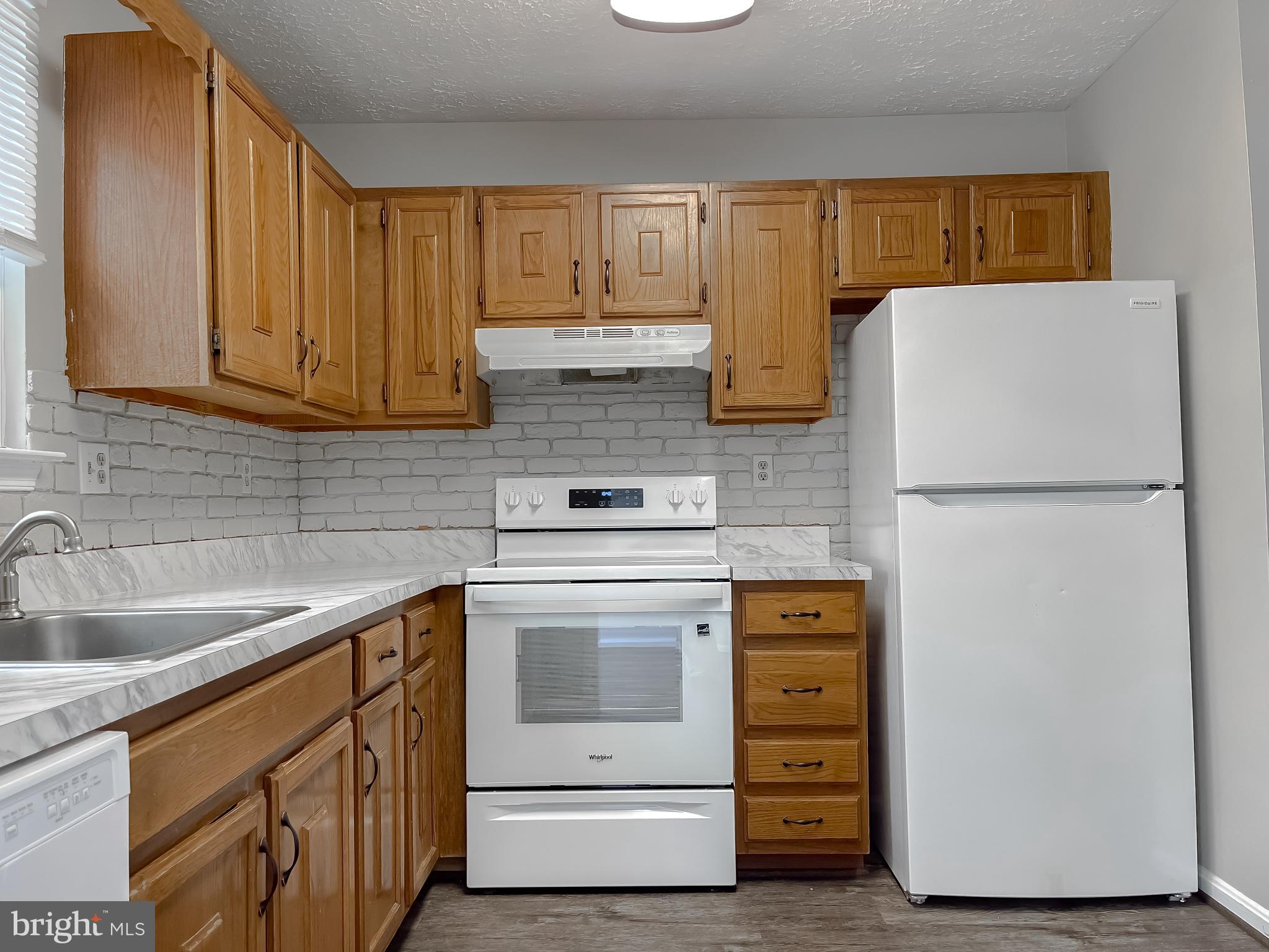 4232 Drake Court Waldorf, MD 20603 - Photo 9 of 25 a kitchen with stainless steel appliances granite countertop a refrigerator sink and cabinets