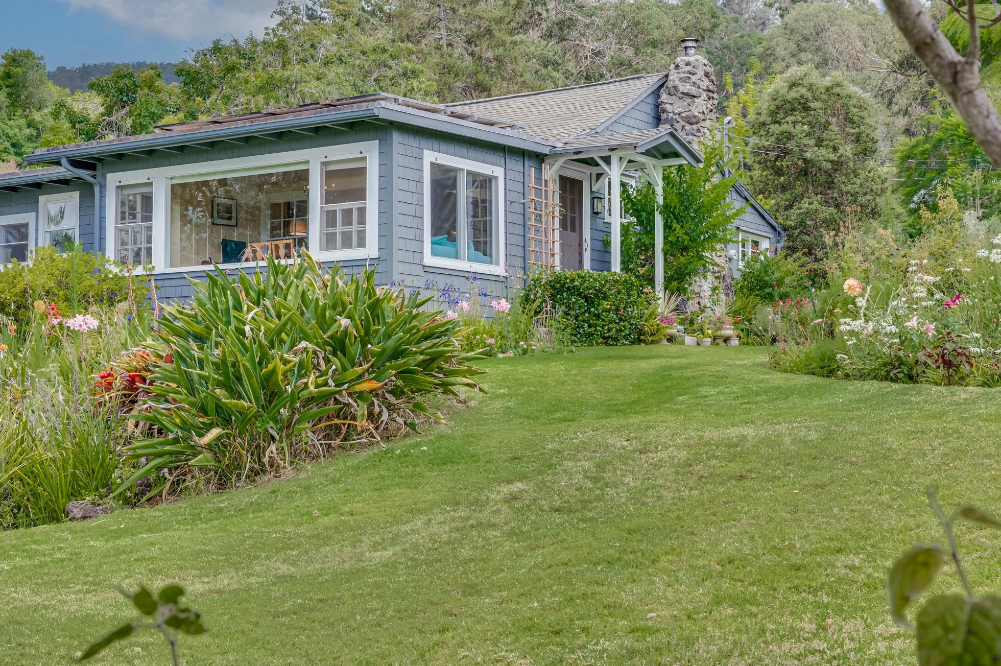 505 Alae Road Kula, HI 96790 - Photo 1 of 36 a front view of a house with a garden