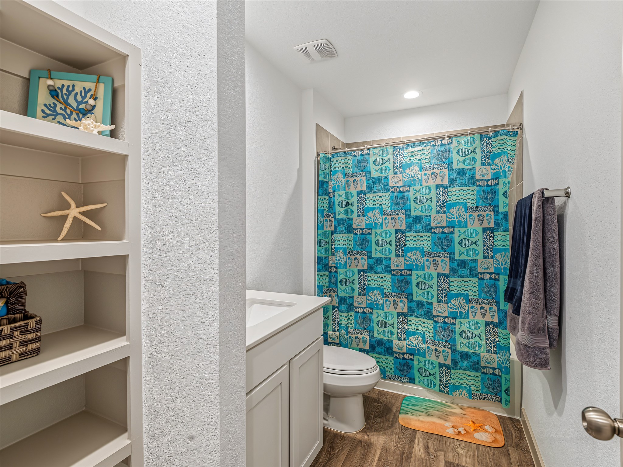 8043 Milam Lane Rosharon, TX 77583 - Photo 26 of 41 This bright secondary bathroom features custom built-in alcove shelving for seamless storage and a full tub/shower combo. Complete with clean white finishes and recessed lighting, it balances style and utility perfectly.
