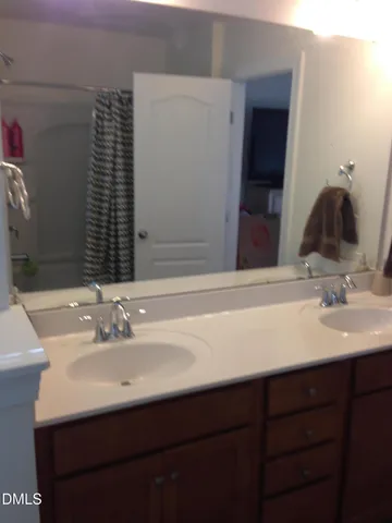 a bedroom with bed and a painting on the wall