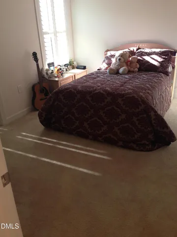 a bedroom with a bed and a television