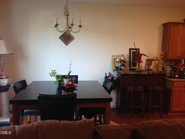 a dining room with furniture and a window
