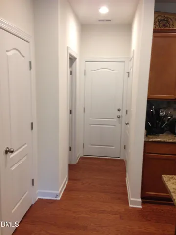 a view of room with hardwood floor and a sink