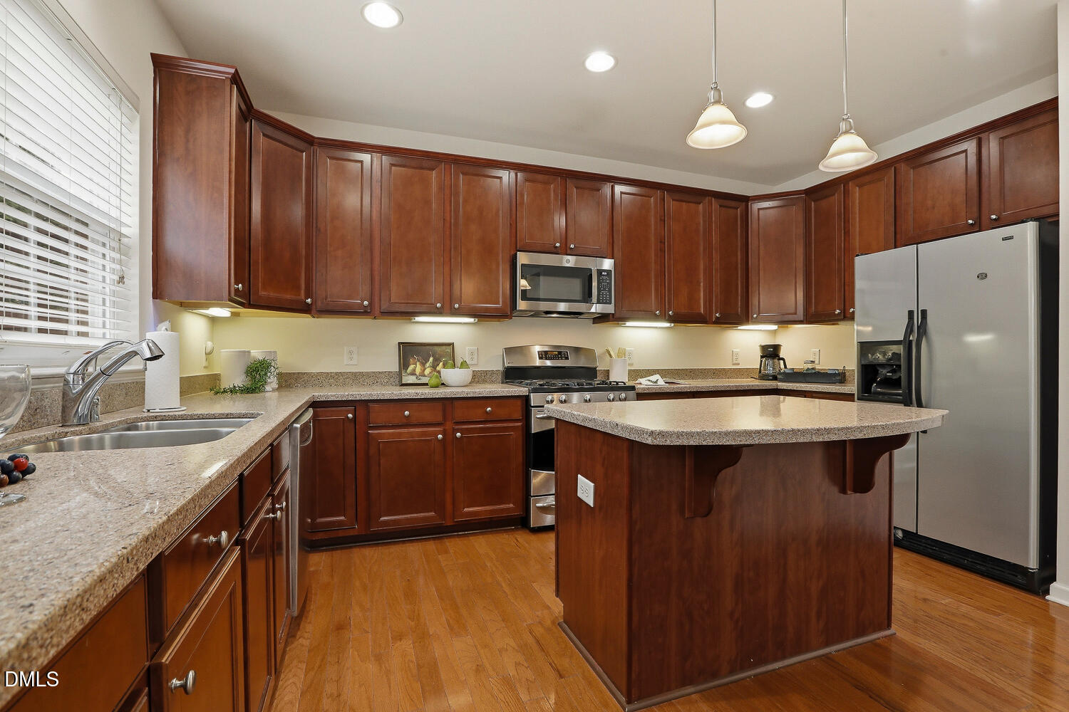 2510 Silverpalm Street Raleigh, NC 27612 - Photo 16 of 65 a kitchen with stainless steel appliances granite countertop a stove refrigerator sink and cabinets