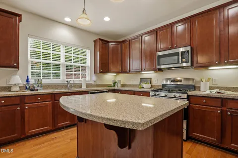 a kitchen with granite countertop a sink and a window