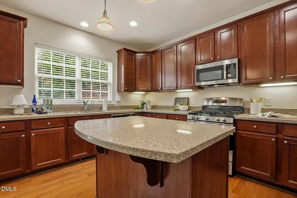 a kitchen with granite countertop a sink and a window