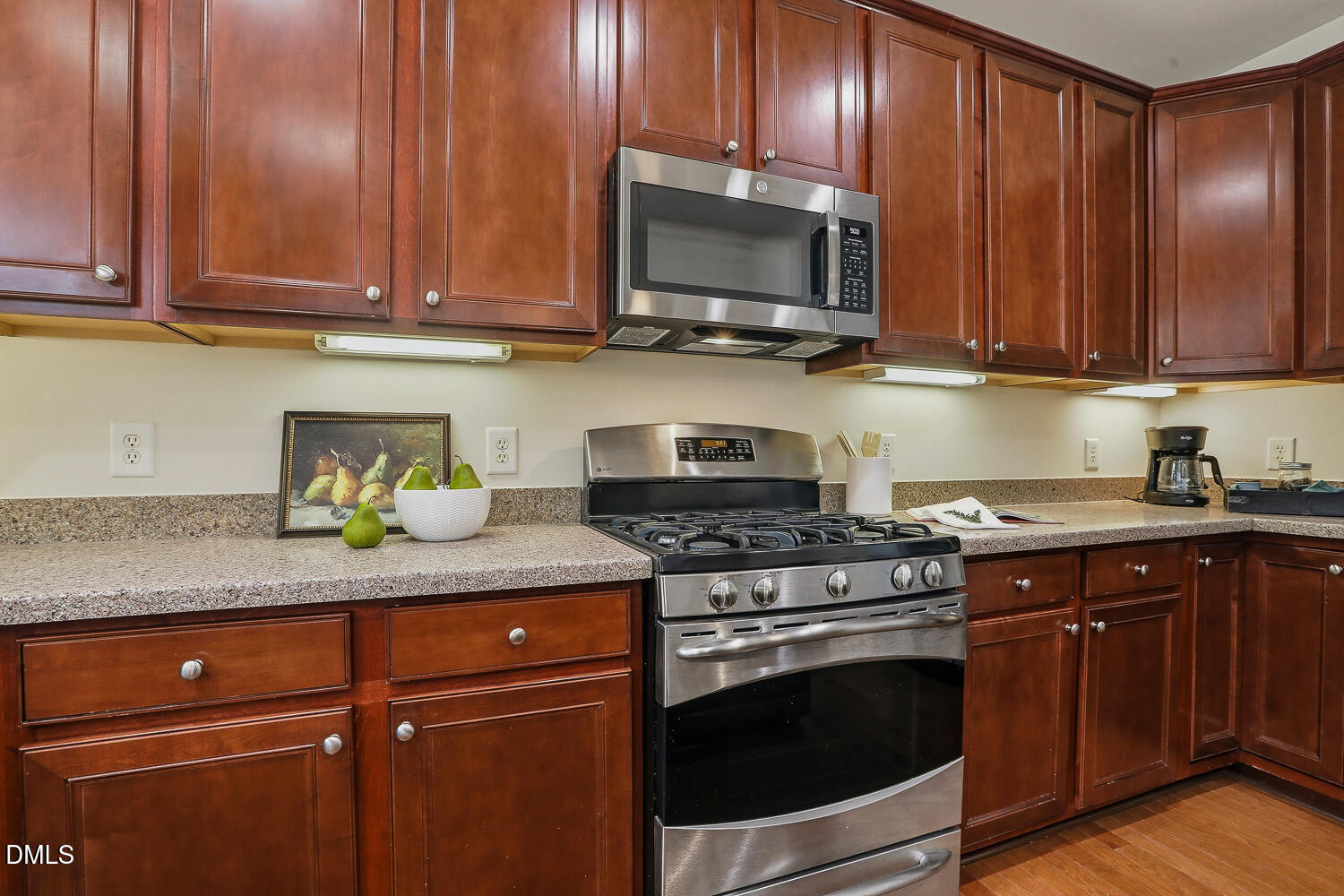 2510 Silverpalm Street Raleigh, NC 27612 - Photo 20 of 65 a kitchen with stainless steel appliances granite countertop wooden cabinets a stove top oven a sink and dishwasher