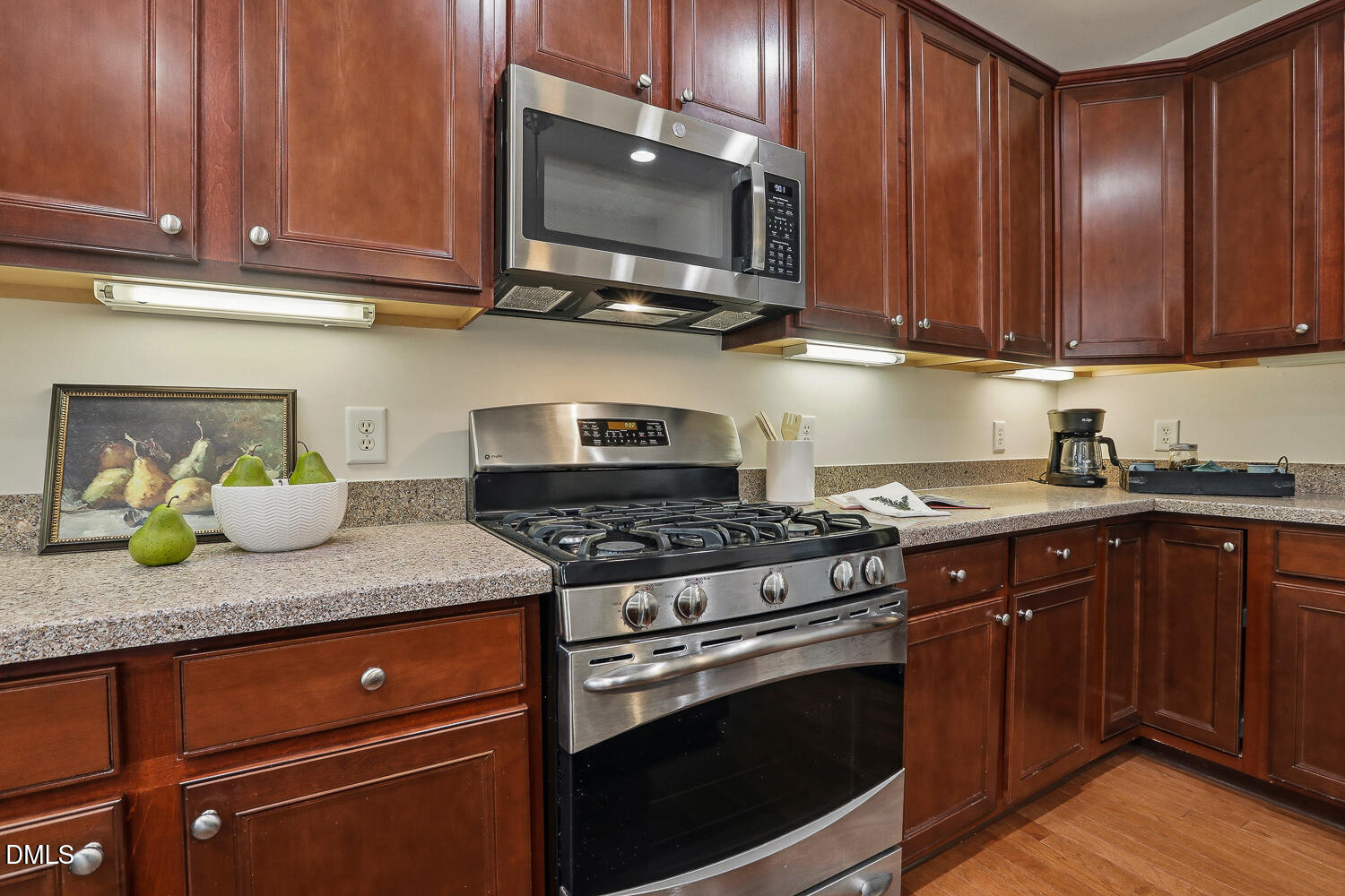 2510 Silverpalm Street Raleigh, NC 27612 - Photo 23 of 65 a kitchen with stainless steel appliances granite countertop wooden cabinets and a stove top oven