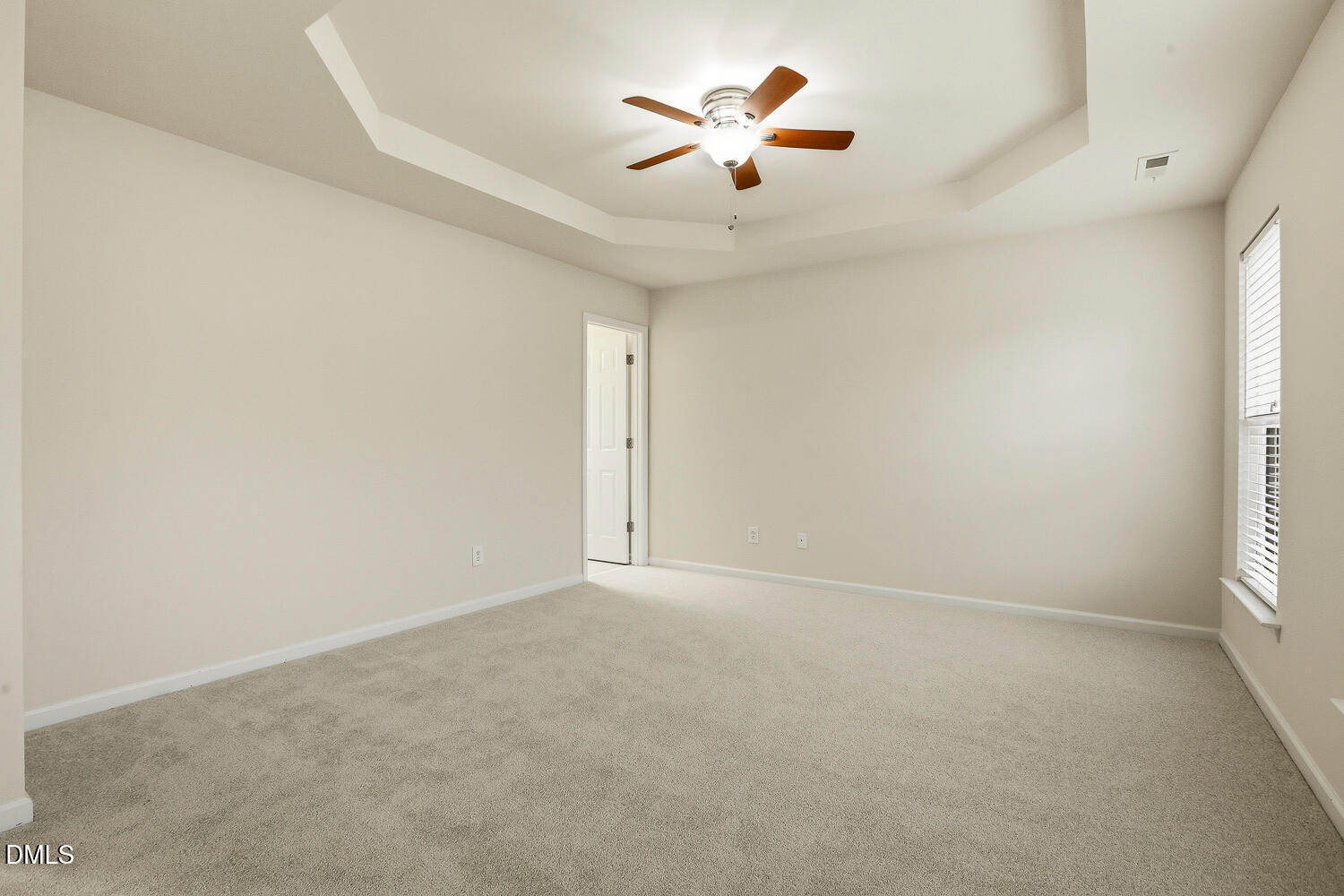 2510 Silverpalm Street Raleigh, NC 27612 - Photo 43 of 65 an empty room with a window and a fan