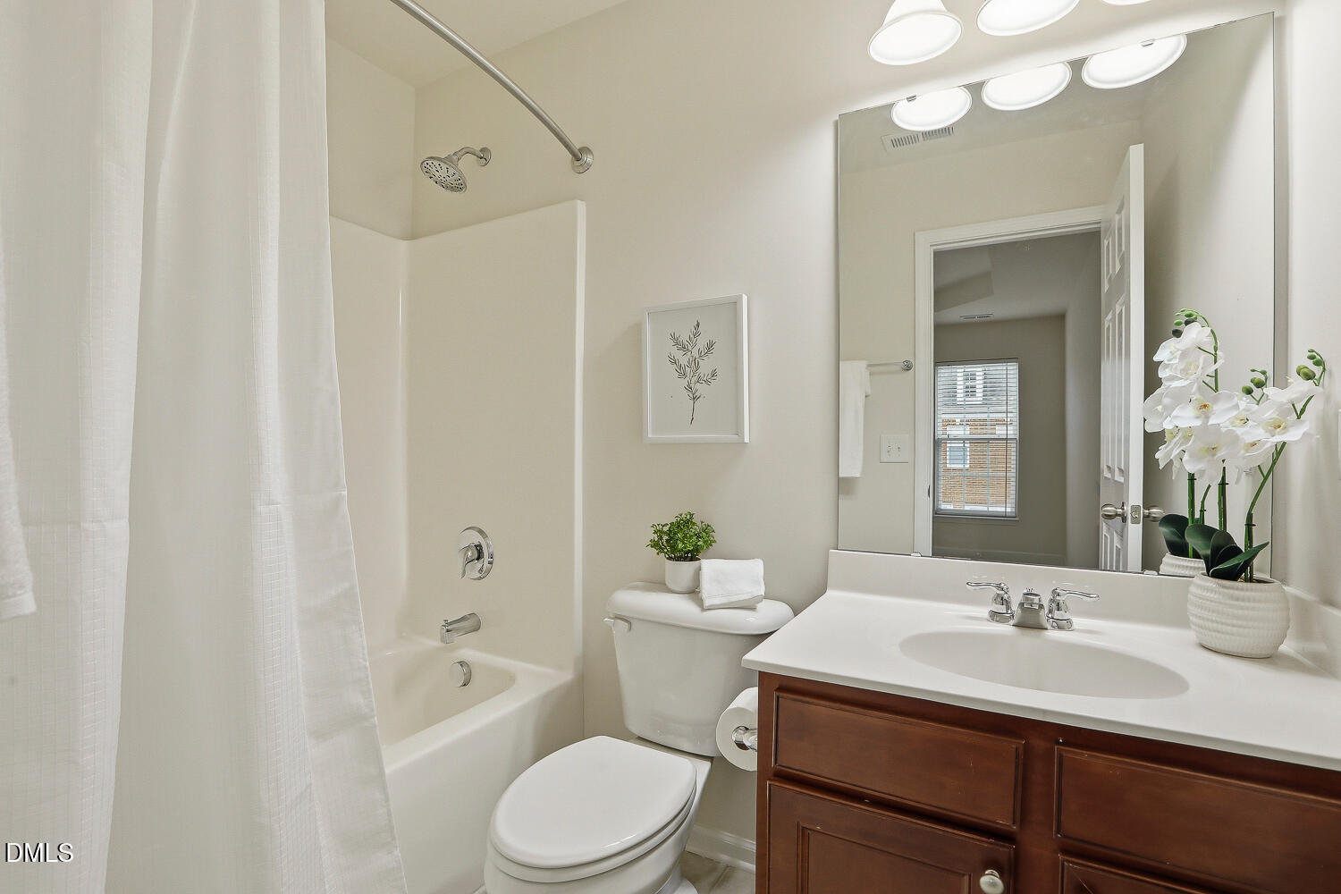 2510 Silverpalm Street Raleigh, NC 27612 - Photo 46 of 65 a bathroom with a toilet a sink a mirror a bathtub and vanity
