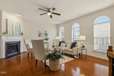 a living room with fireplace furniture and a wooden floor
