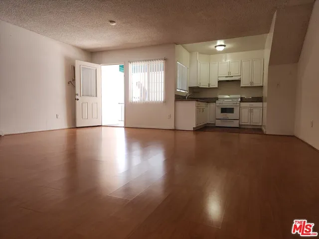 a view of kitchen with cabinets and wooden floor