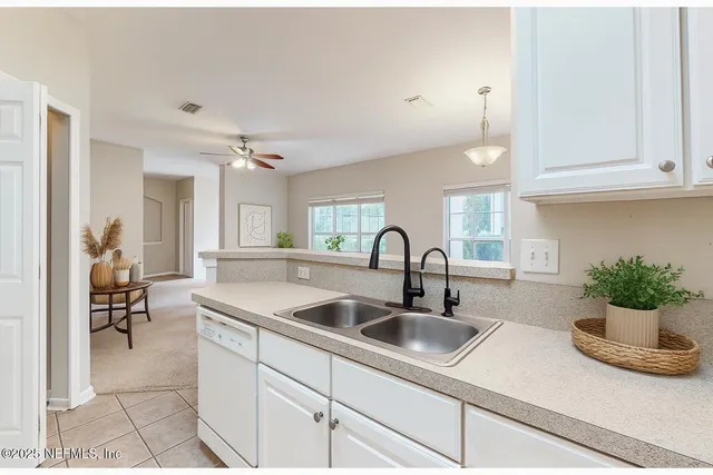 a kitchen with white cabinets sink and white appliances