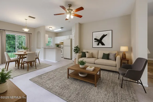 a view of a dining room with furniture and chandelier