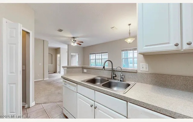 a white refrigerator freezer sitting in a kitchen