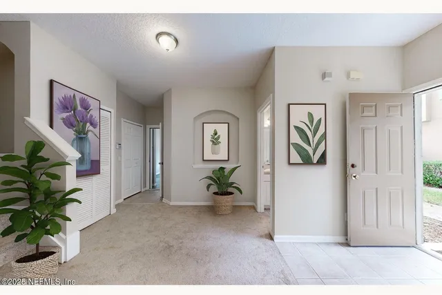 a kitchen with sink and view of living room