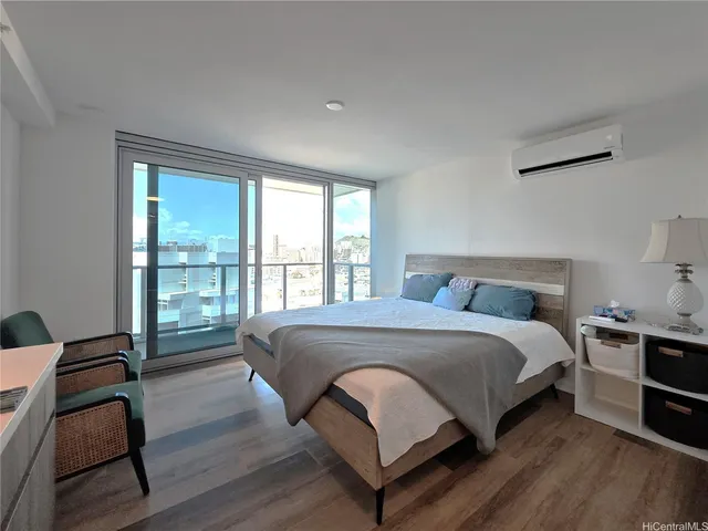 a bedroom with a bed and wooden floor