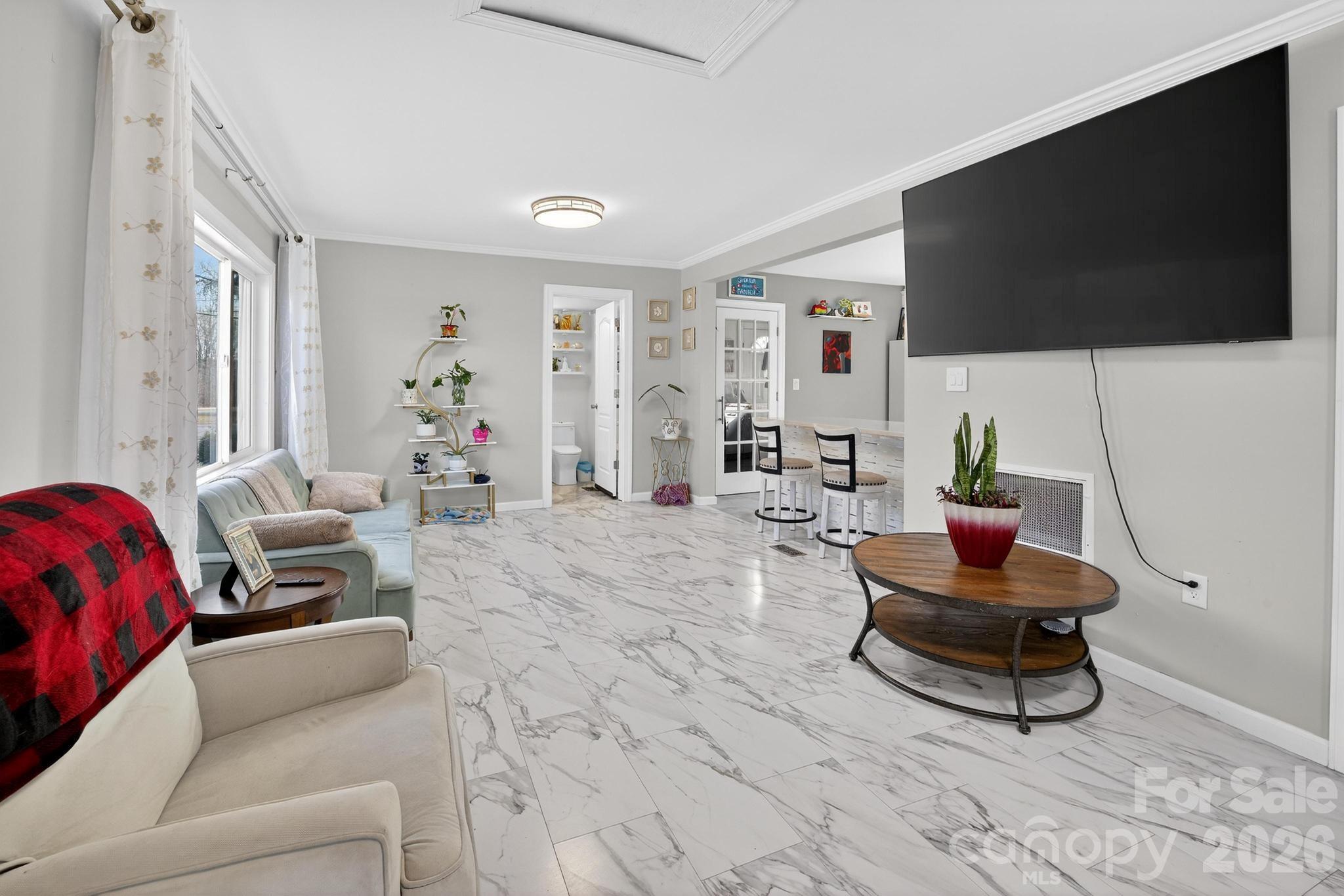 105 Countryside Drive Southwest Lenoir, NC 28645 - Photo 12 of 43 a living room with furniture and a flat screen tv