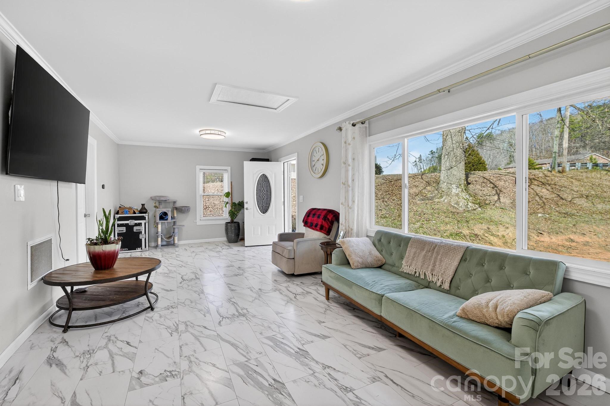 105 Countryside Drive Southwest Lenoir, NC 28645 - Photo 15 of 43 a living room with furniture and a flat screen tv