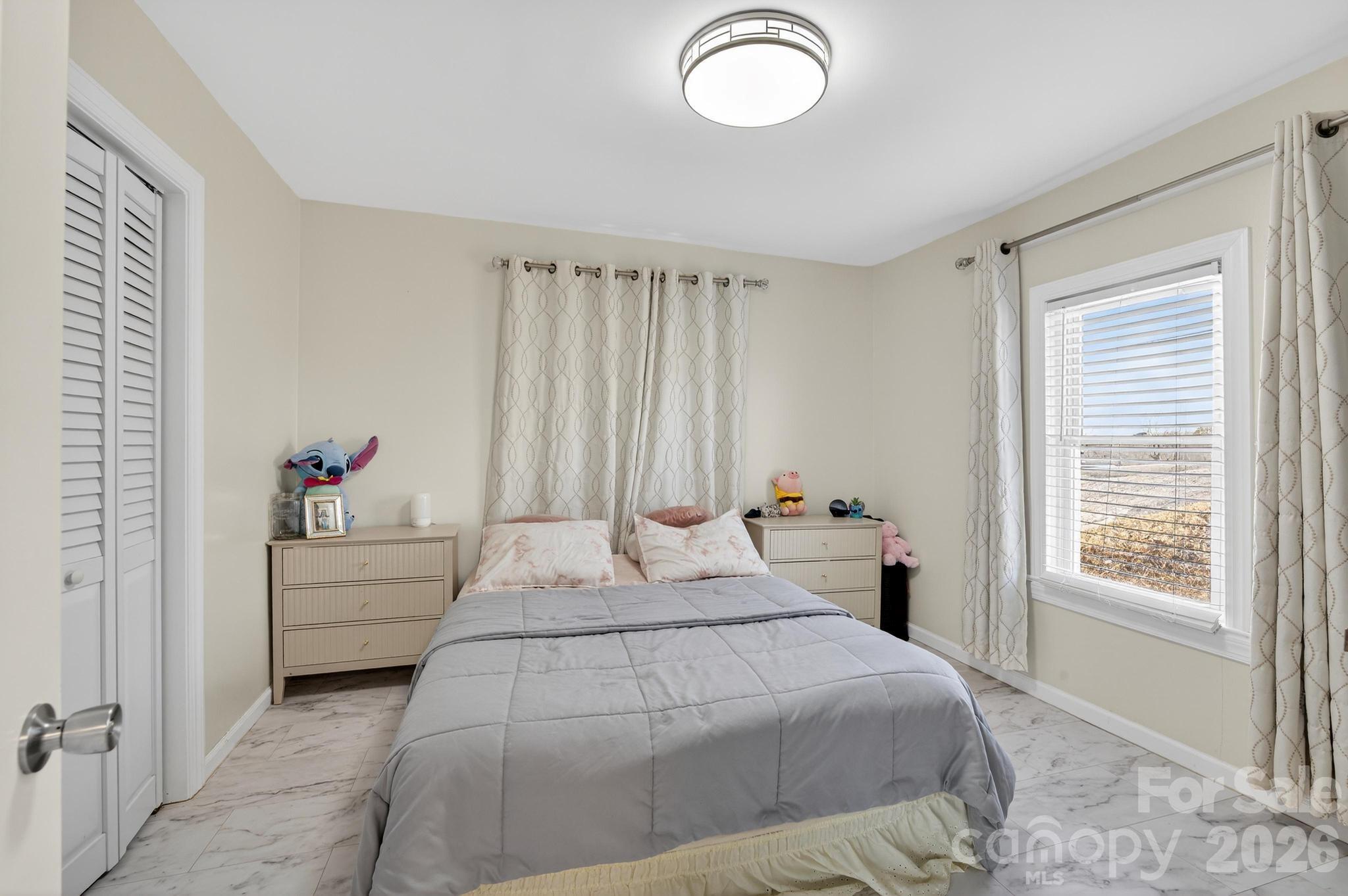 105 Countryside Drive Southwest Lenoir, NC 28645 - Photo 19 of 43 a bedroom with a large bed and a window