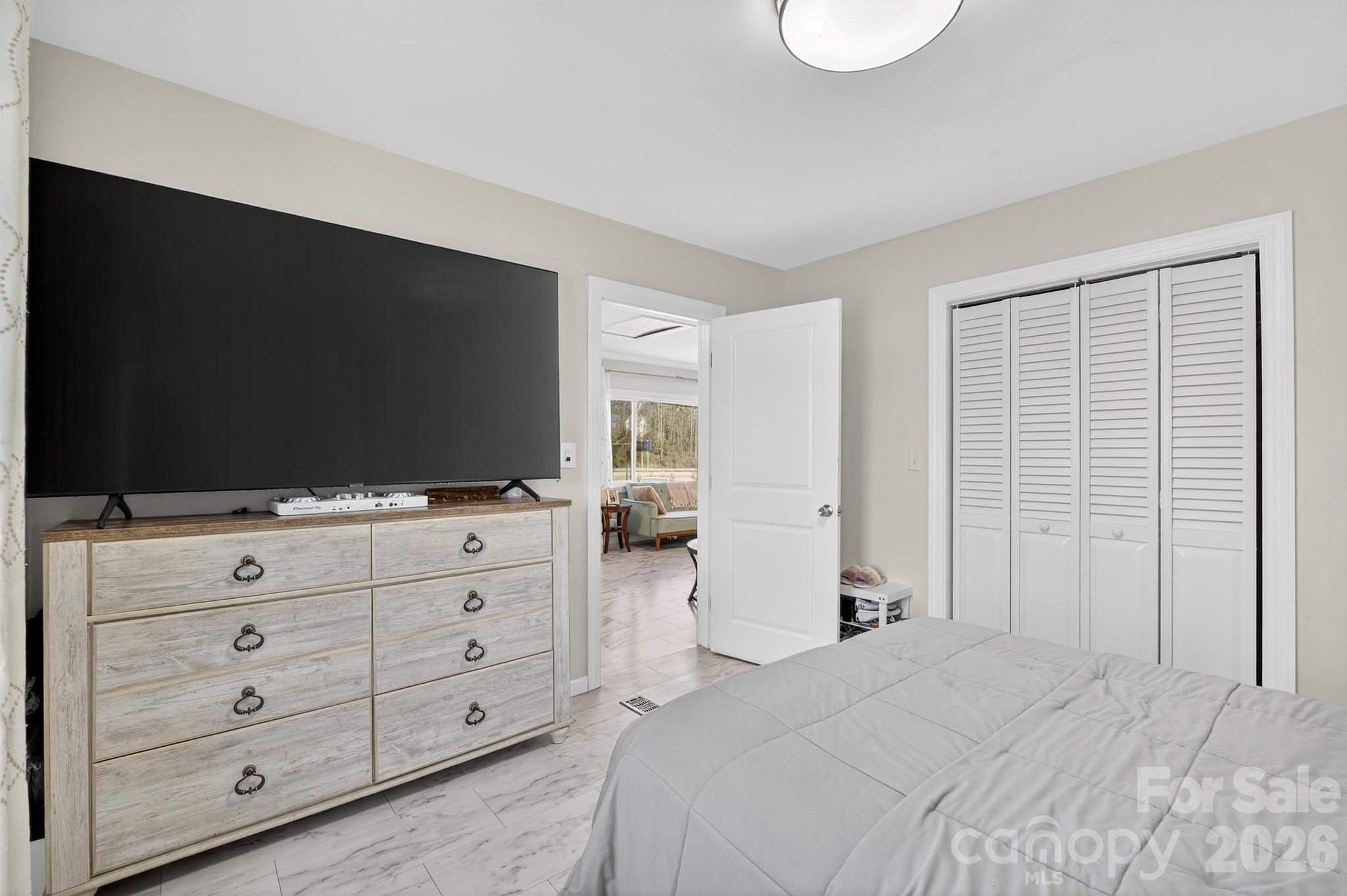 105 Countryside Drive Southwest Lenoir, NC 28645 - Photo 20 of 43 a bedroom with a bed and a flat screen tv in white cabinet
