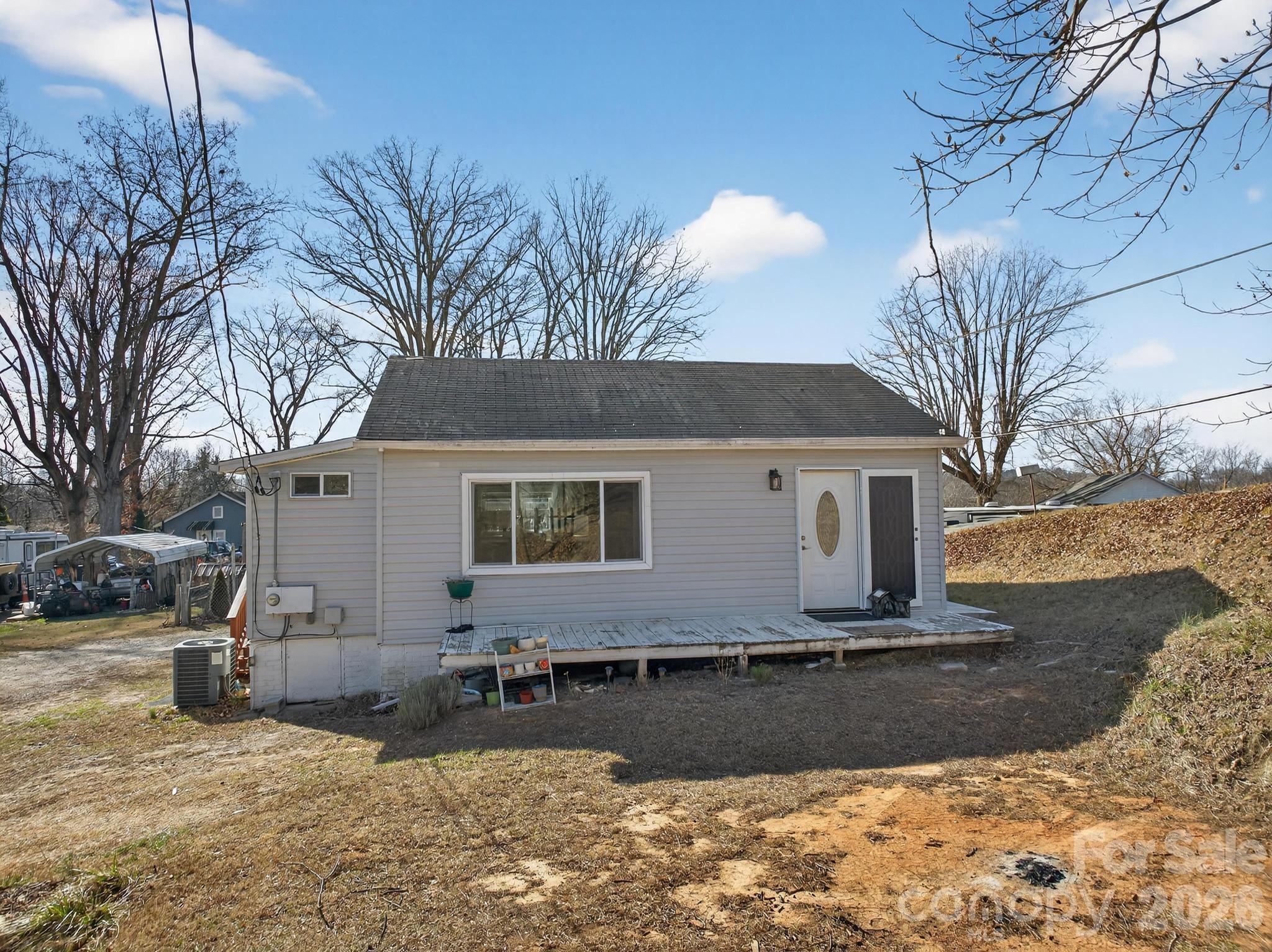 105 Countryside Drive Southwest Lenoir, NC 28645 - Photo 35 of 43 a view of a white house with a yard covered in snow