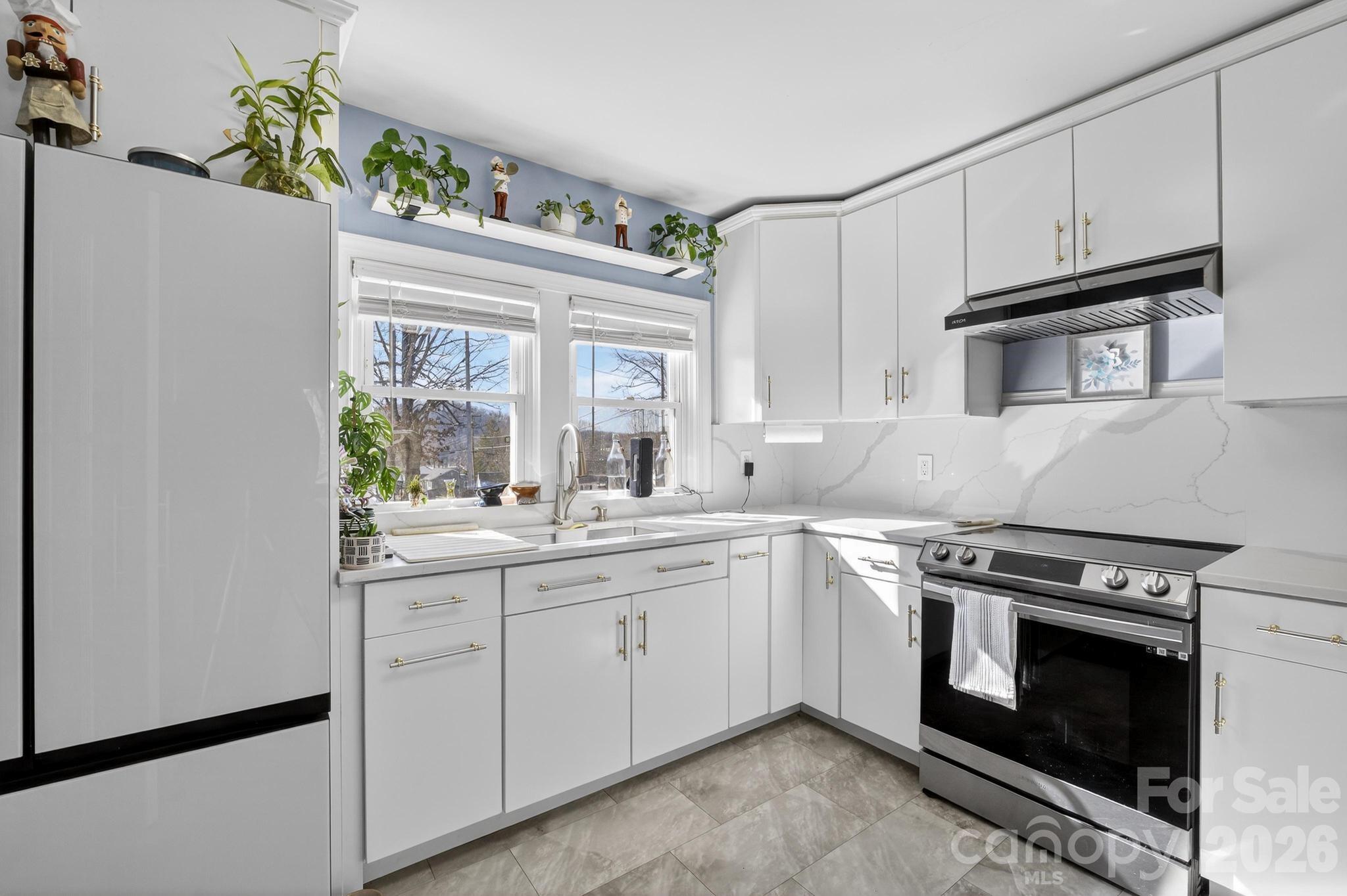 105 Countryside Drive Southwest Lenoir, NC 28645 - Photo 4 of 43 a kitchen with granite countertop a sink stainless steel appliances and cabinets