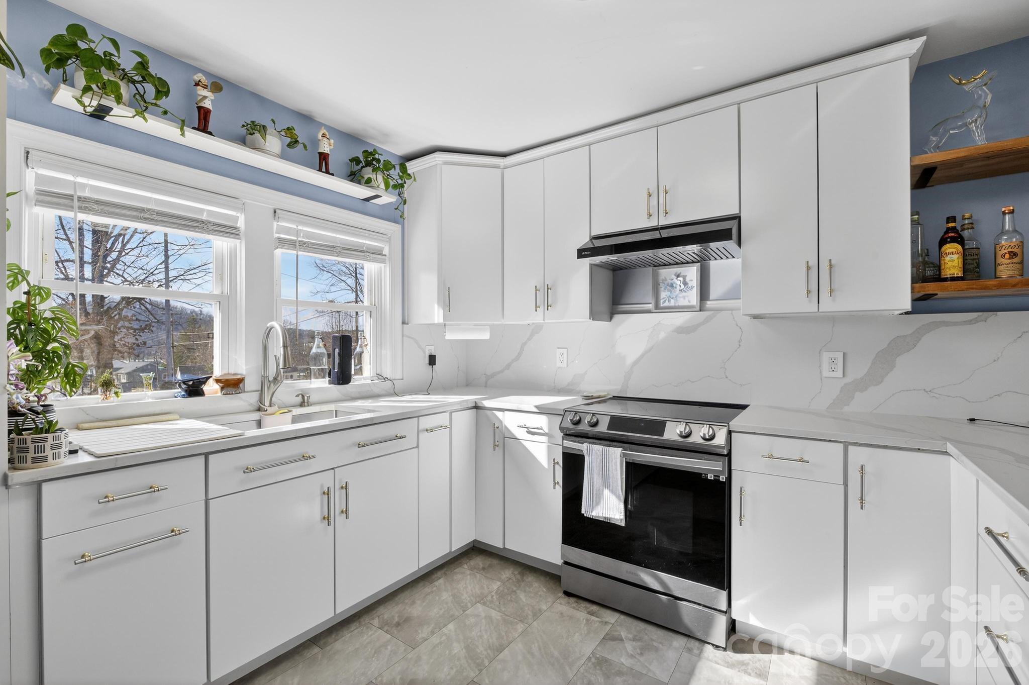 105 Countryside Drive Southwest Lenoir, NC 28645 - Photo 10 of 43 a kitchen with white cabinets stainless steel appliances and sink
