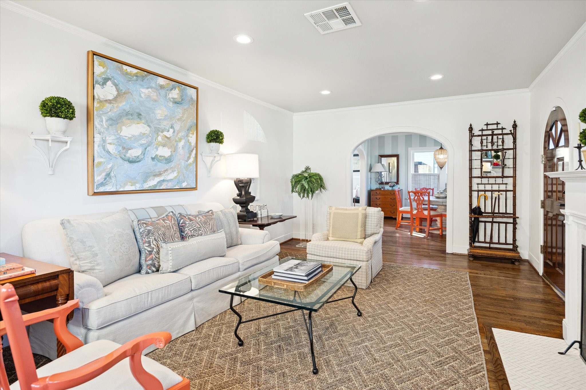 2109 Colquitt Street Houston, TX 77098 - Photo 6 of 28 The living space flows effortlessly toward the arched doorway, creating an inviting connection to the dining room beyond.
