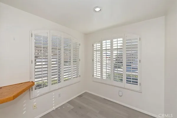 a view of a room with wooden floor and potted plant
