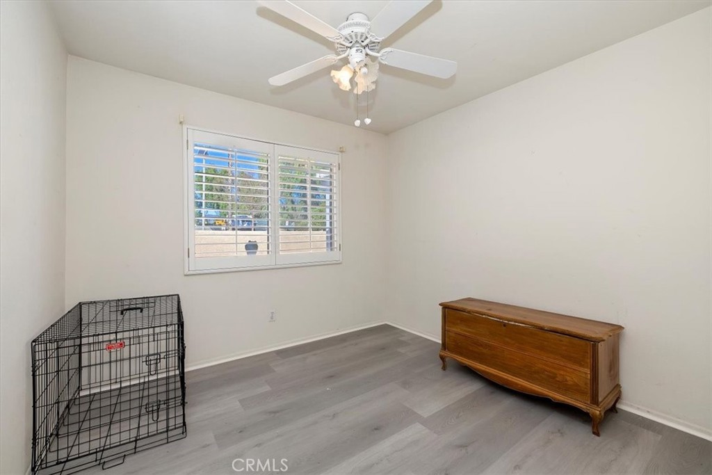 5509 Rodriguez Avenue Banning, CA 92220 - Photo 19 of 36 a room with a bed and a chandelier