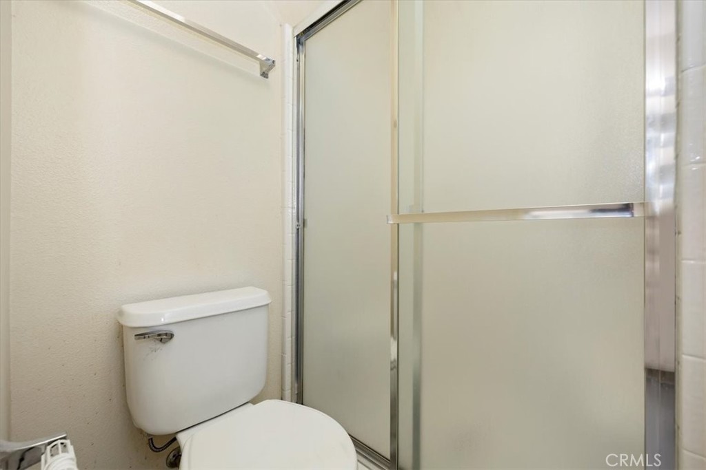 5509 Rodriguez Avenue Banning, CA 92220 - Photo 25 of 36 a white toilet sitting next to a shower