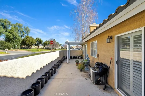 a view of a patio with couches and potted plants