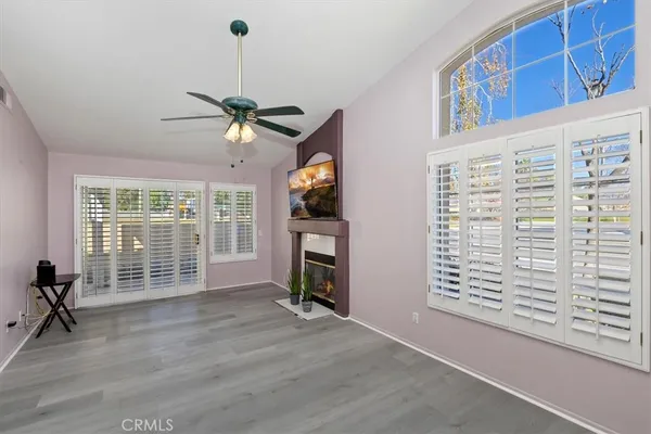 a view of an empty room with a window and a fireplace
