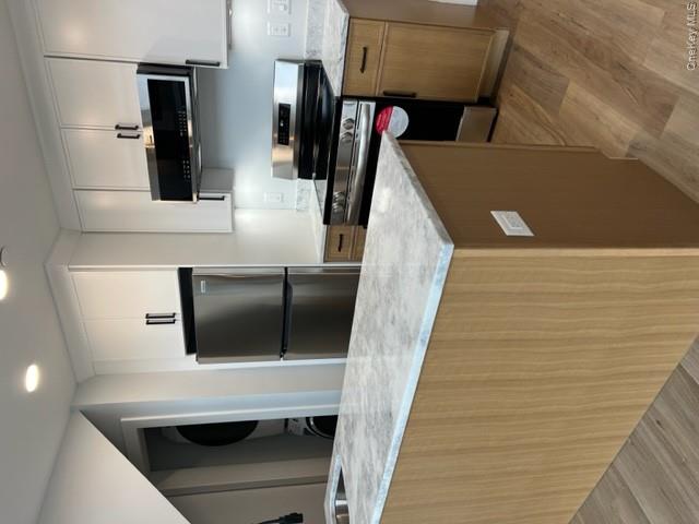 42 North Main Street, Unit 6 Florida, NY 10921 - Photo 5 of 7 a kitchen with stainless steel appliances granite countertop a refrigerator a stove a sink and a microwave