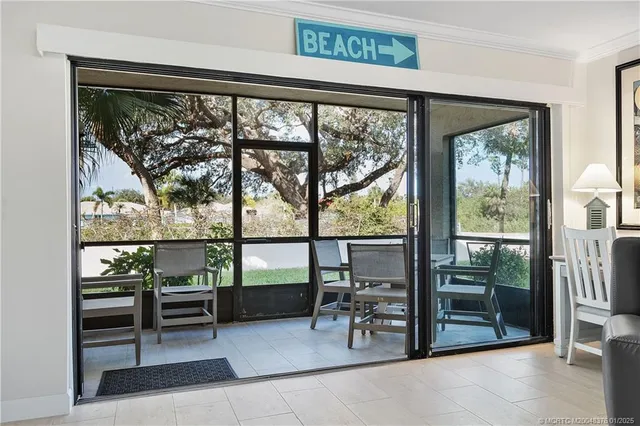 a view of a room with wooden floor and outdoor seating