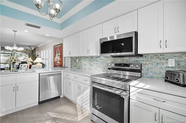 a kitchen with appliances a sink and cabinets