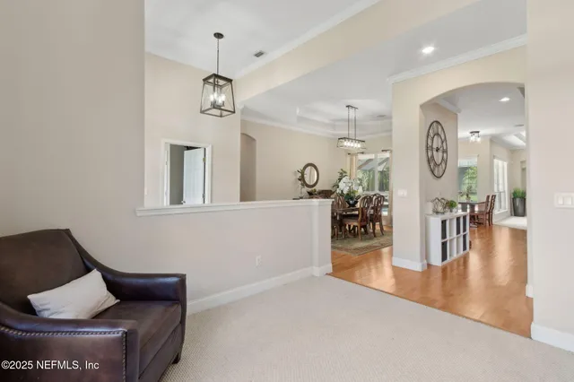 a kitchen with kitchen island granite countertop a sink cabinets and wooden floor
