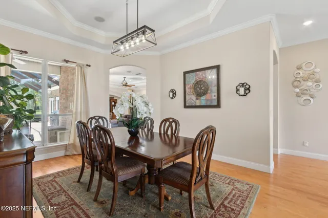 a kitchen with stainless steel appliances granite countertop a sink a stove top oven a clock and cabinets