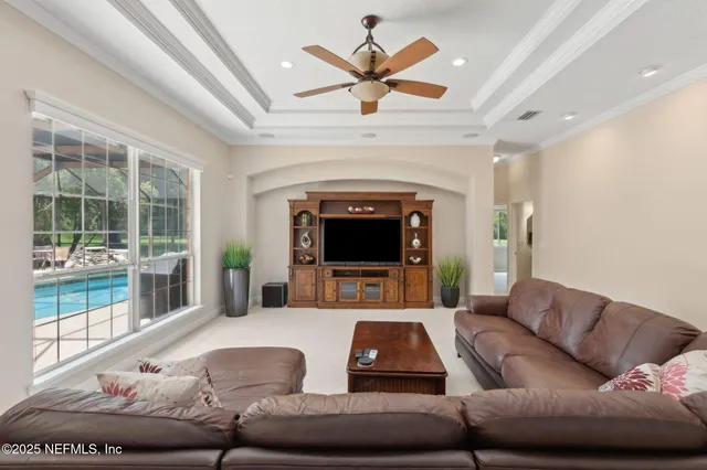 a spacious bedroom with a bed and a flat screen tv