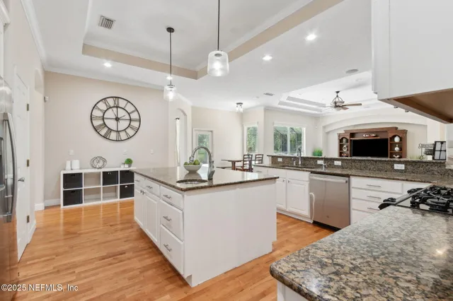 a bathroom with a sink a toilet and a large mirror