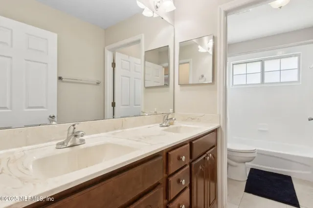 a front view of a house with a yard garden and seating area