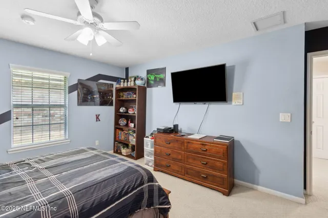 a view of swimming pool with outdoor seating and a potted plant