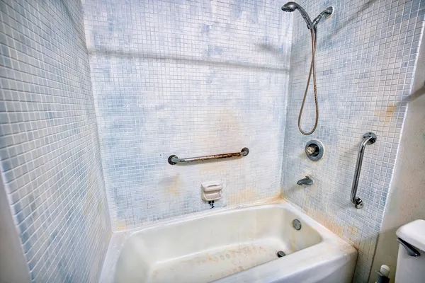 a bathroom with a granite countertop toilet sink and mirror