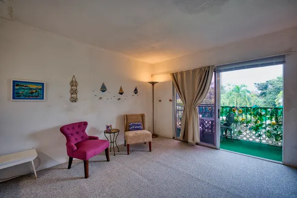 a view of a livingroom with furniture and a window