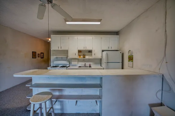 a kitchen with a table chairs stove and microwave