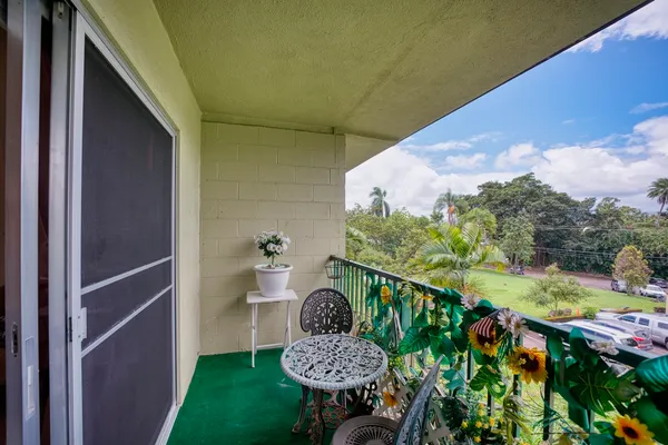 a view of a balcony with potted plants
