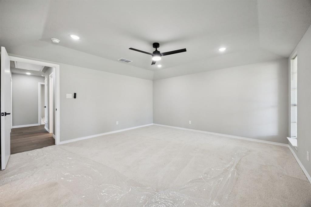 10 Chisholm Trail Lucas, TX 75002 - Photo 31 of 40 wooden floor in an empty room with a ceiling fan